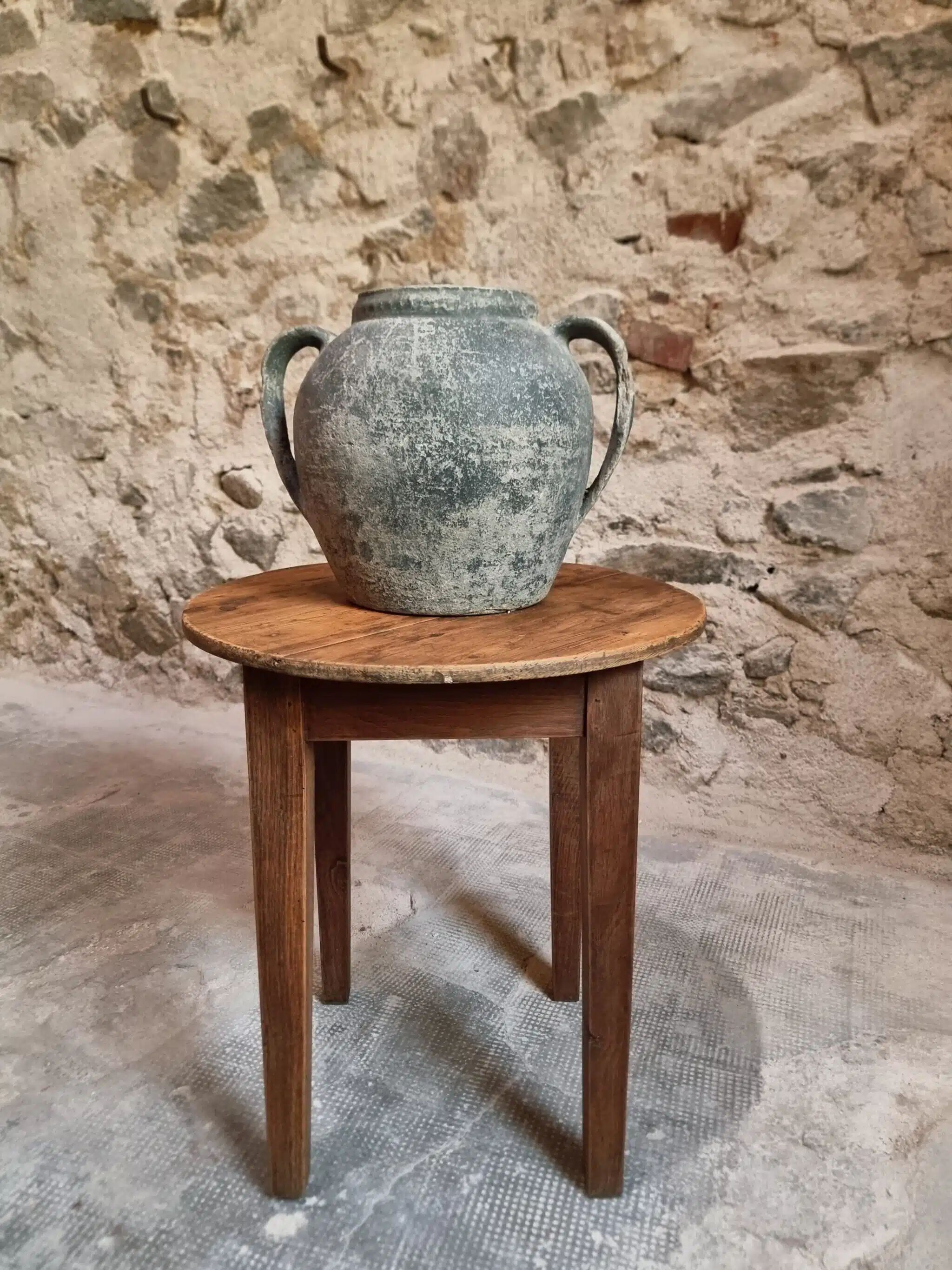 Antique round side table with oak legs and a pine top, circa 1900.