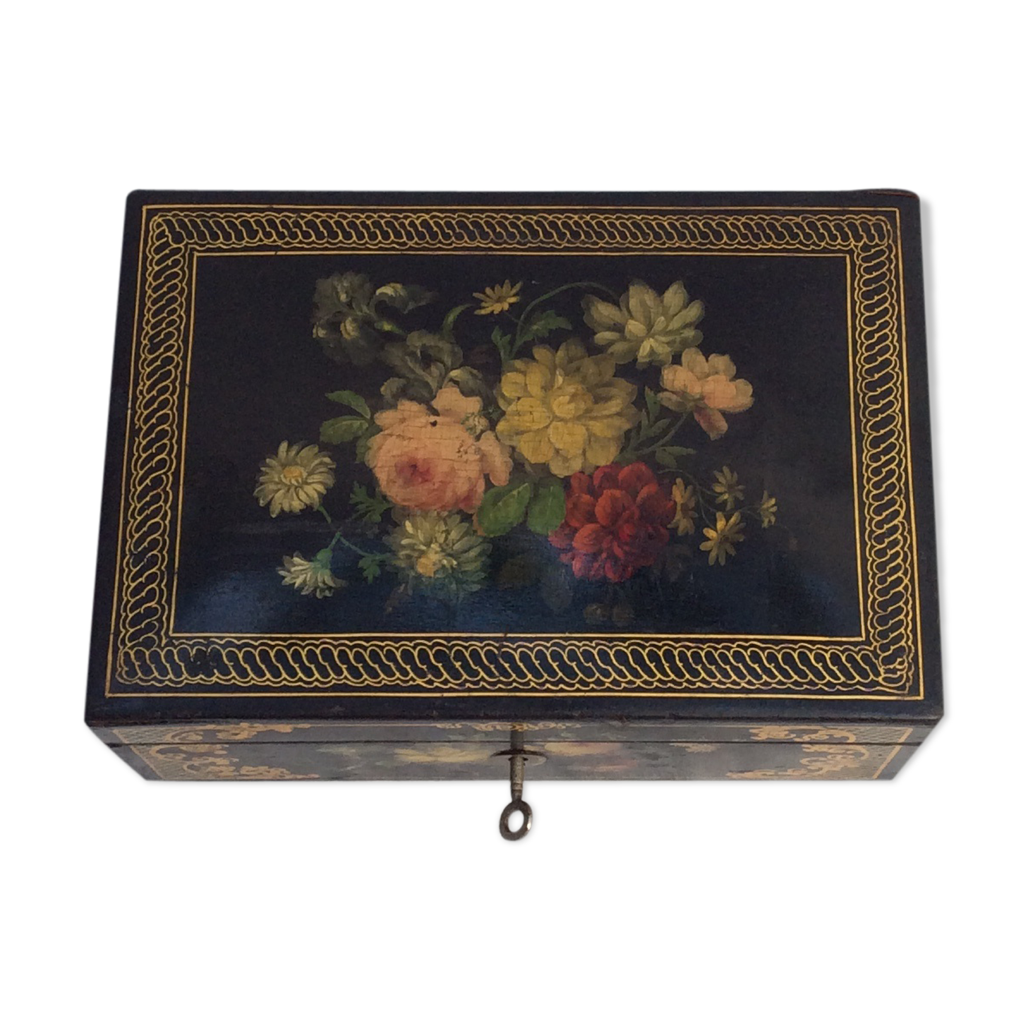 Old black wooden box adorned with roses with keys