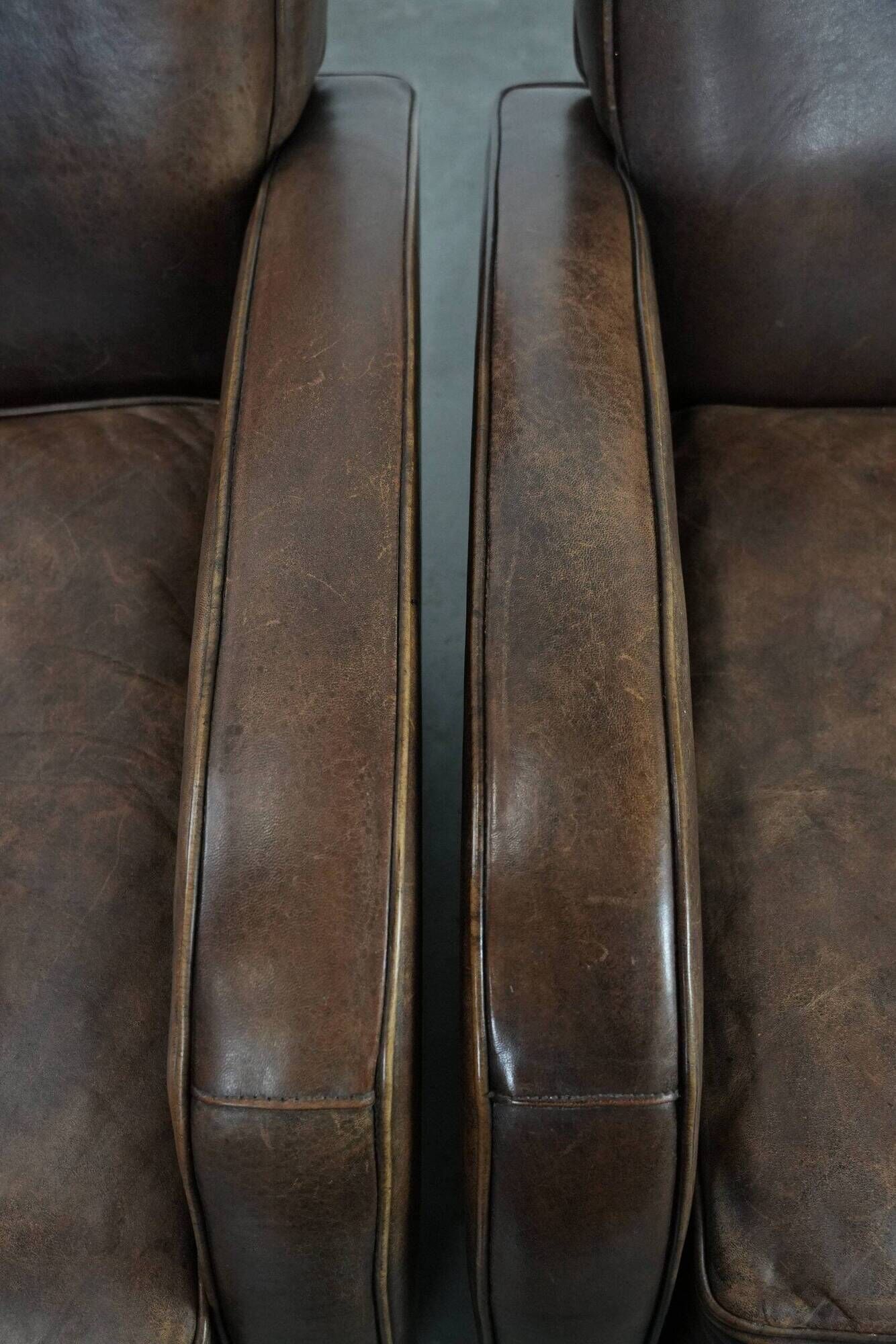 Elegant set of two sheepskin leather armchairs with beautiful round shapes