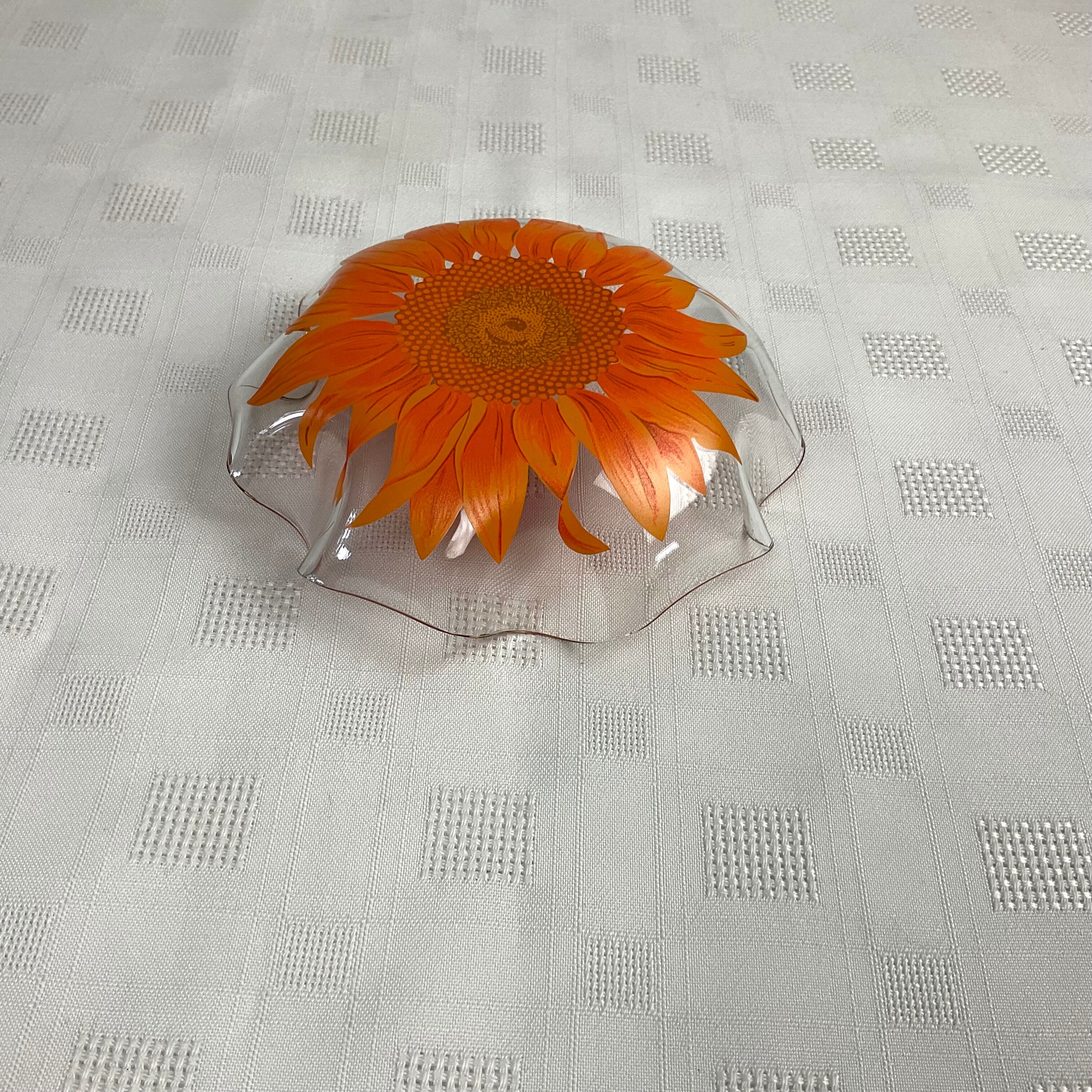 Glass cup with orange sunflower