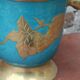Vintage turquoise brass champagne bucket with grape decoration.