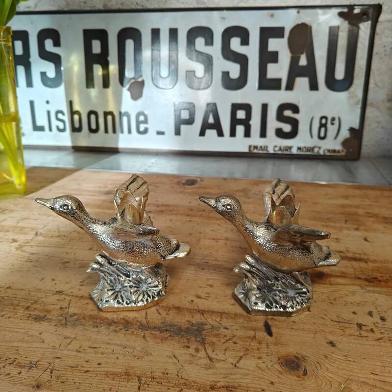 Set of two antique silver-plated duck candlesticks.