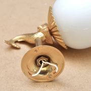 Pair of gold metal and opaque glass wall lights adorned with fish from the 1950s.
