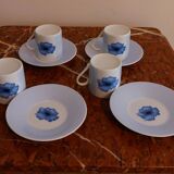 Set of four coffee cups with plates