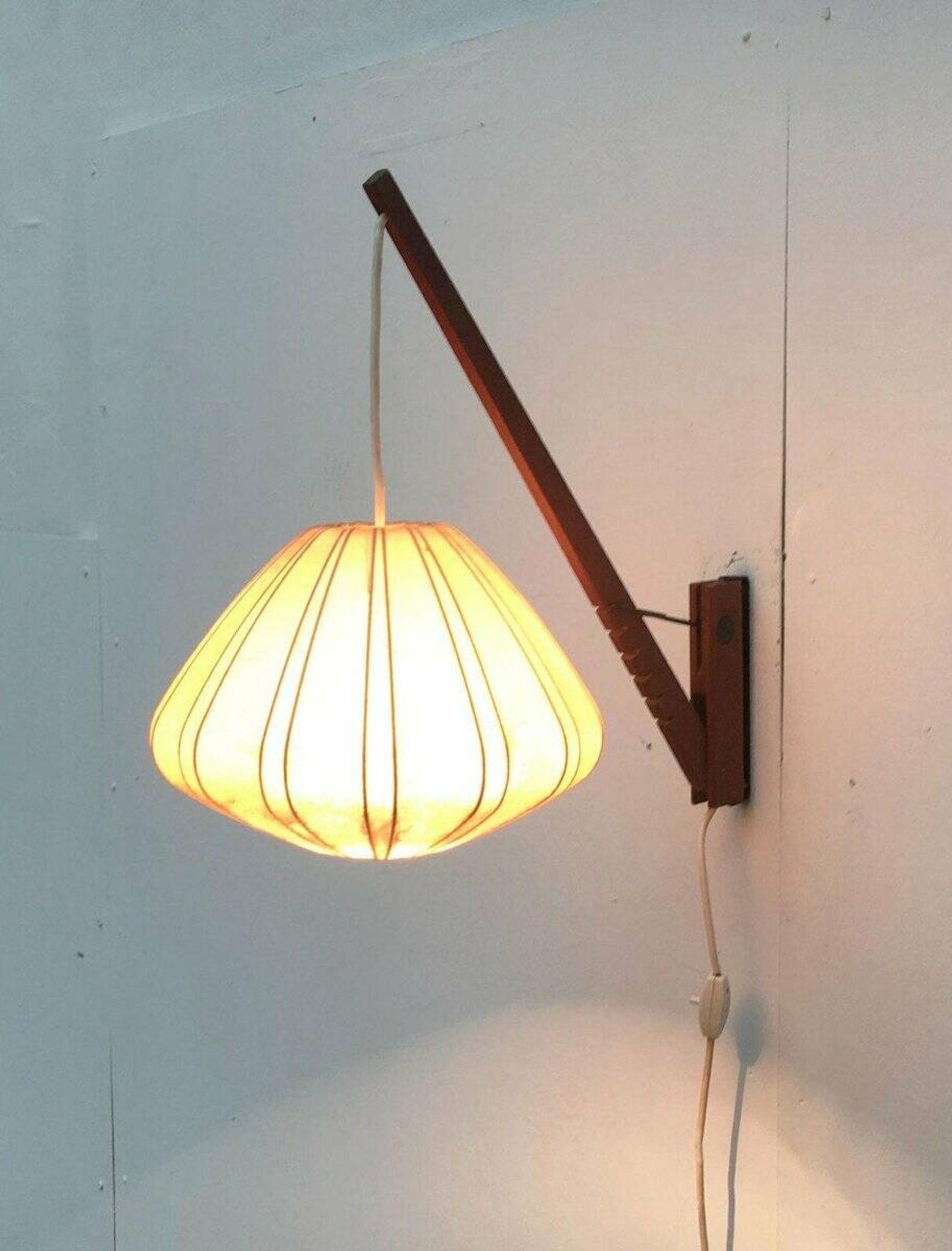 Mid-century pivoting wall lamp with a swing arm, Cocoon, made of teak wood, 1960s.