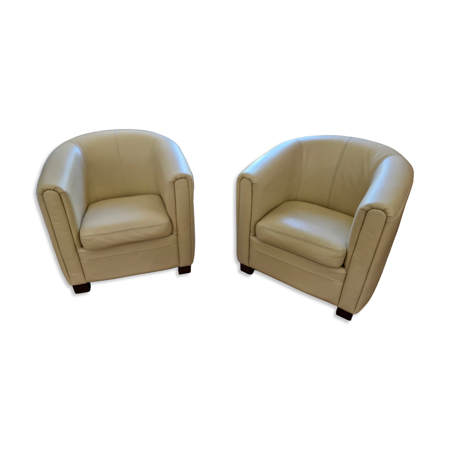 A pair of genuine leather club armchairs.