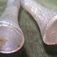 Pair of iridescent glass vases with relief decoration reminiscent of plant motifs.
