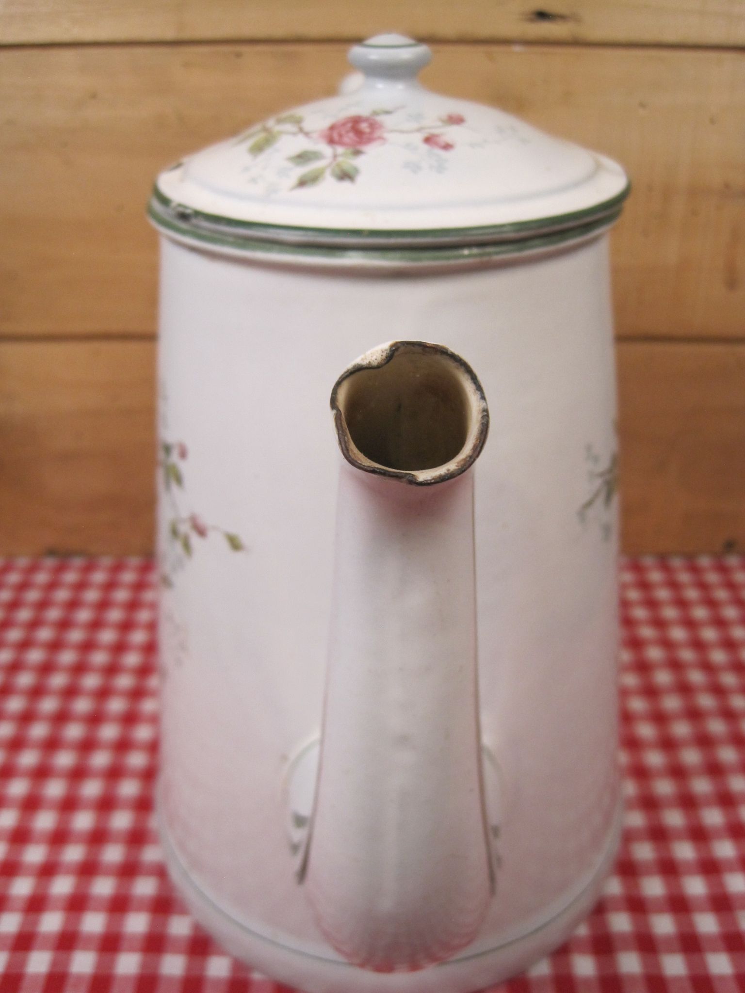 Old coffee maker in enamelled sheet metal brand bb 1900s , decoration of roses , kitchen utensils