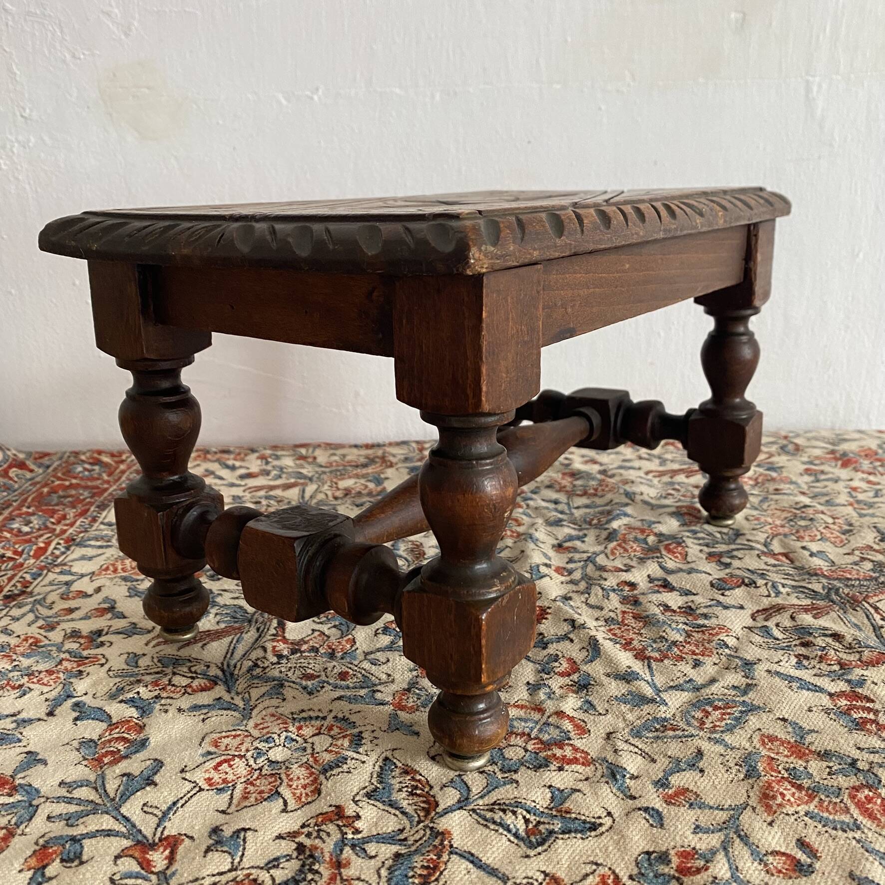 Low stool in carved wood