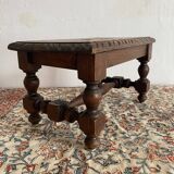 Low stool in carved wood