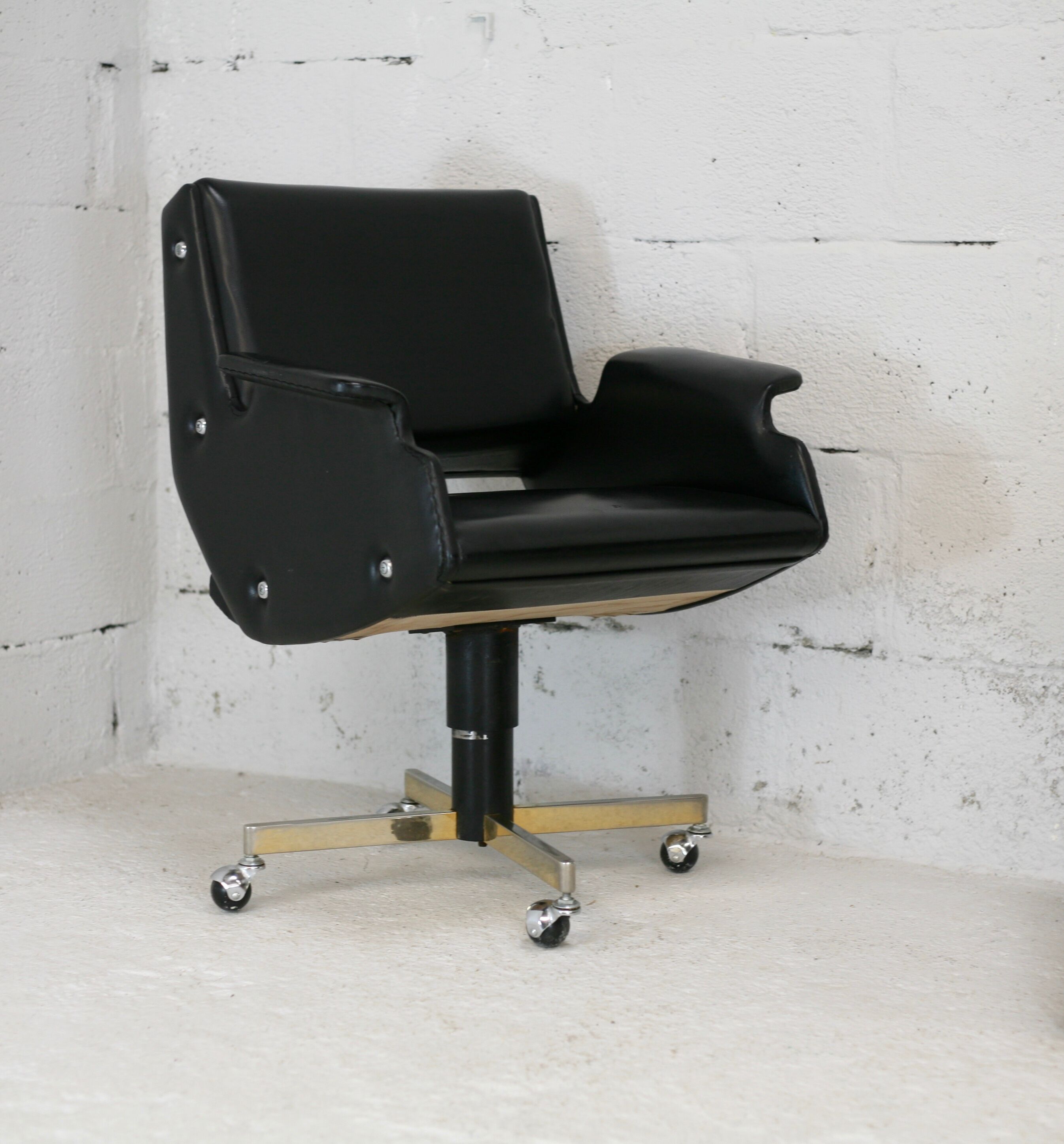 Pair of swivel armchairs, imitation leather and steel, Italy, circa 1960.