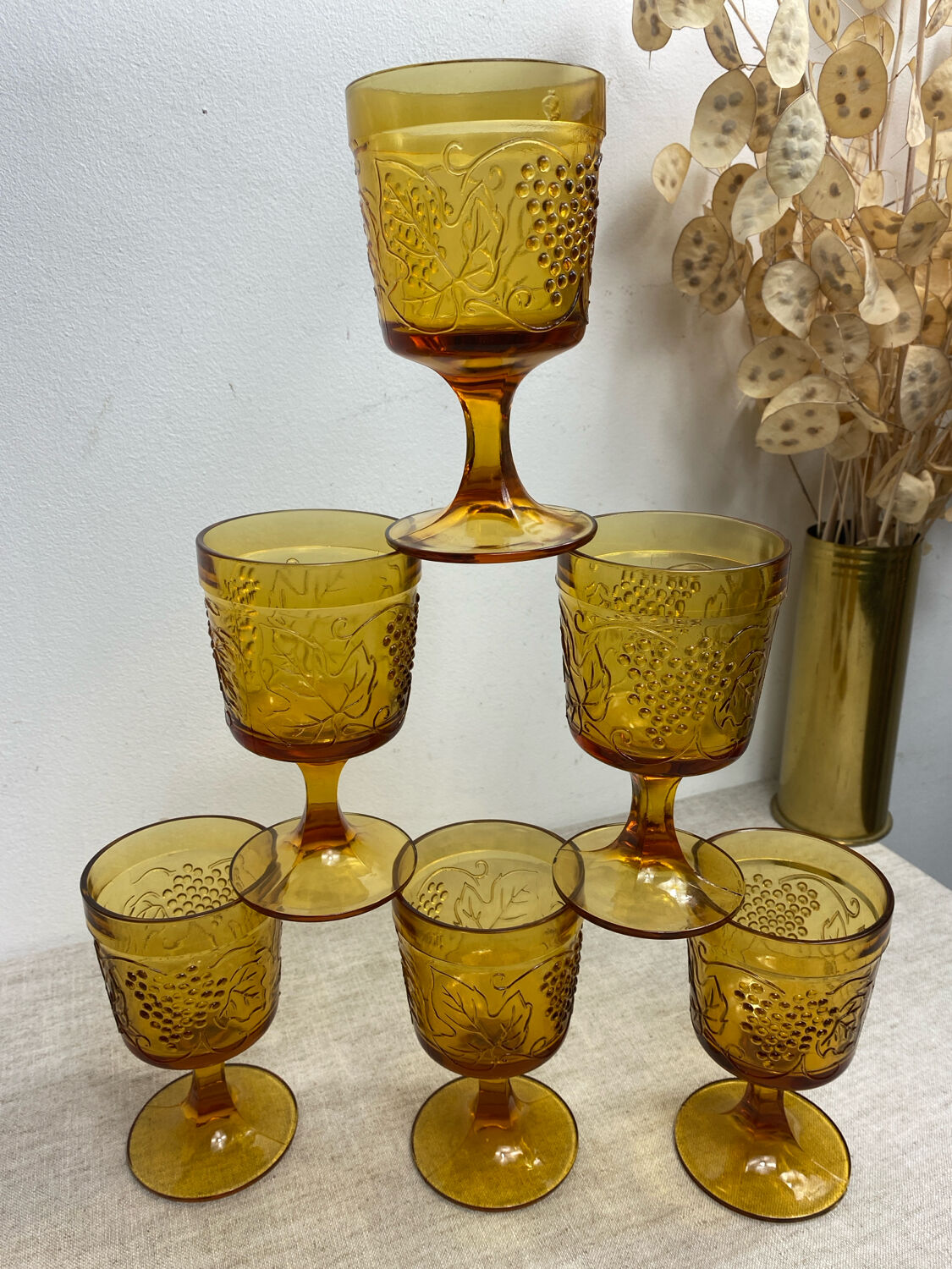Six stemmed glasses in amber-colored molded glass