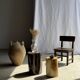 Black petrified wood side table with beige stripes and a semicircular shape.