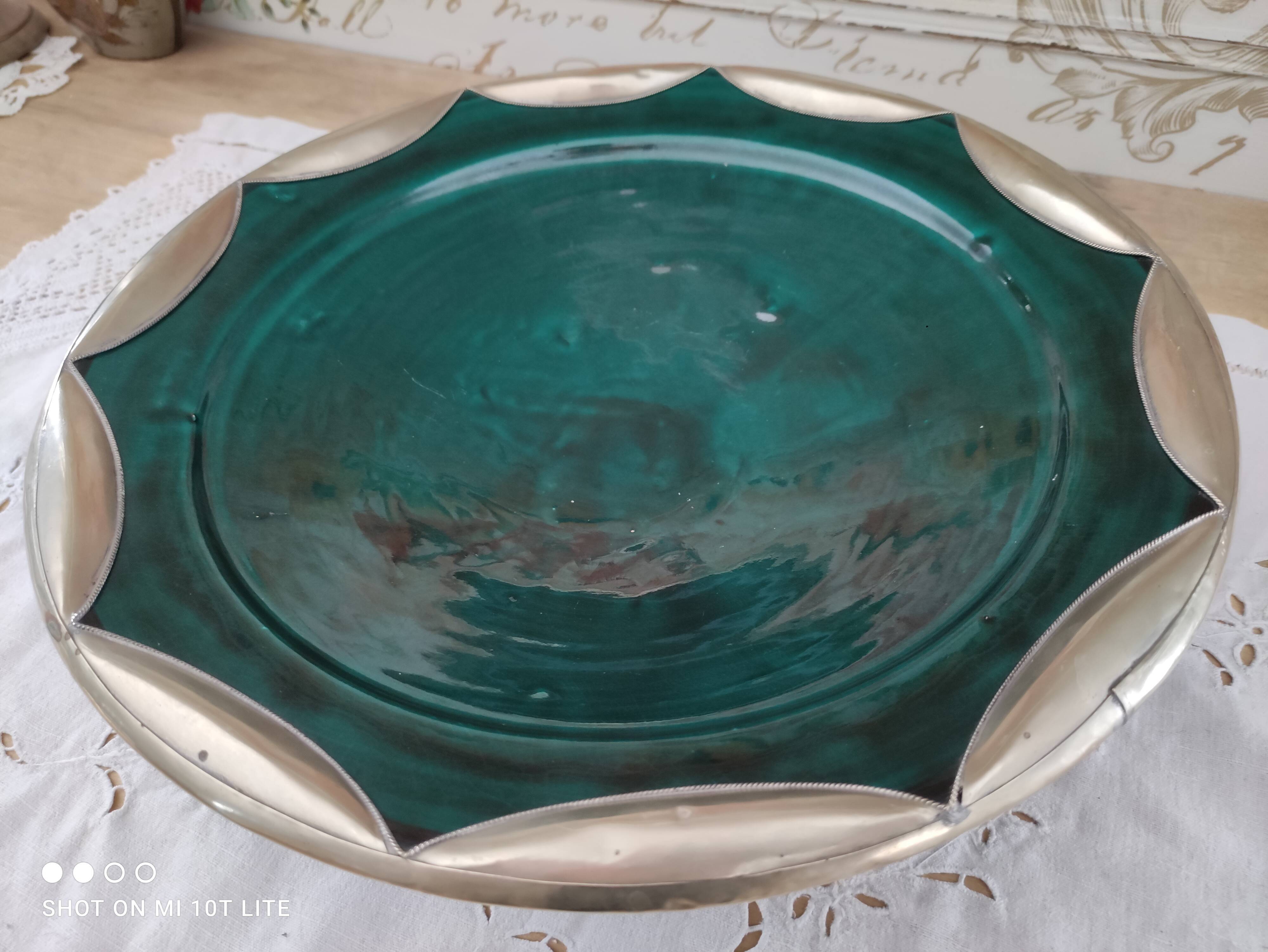 Round oriental hollow dish in deep green ceramic and silver colored metal