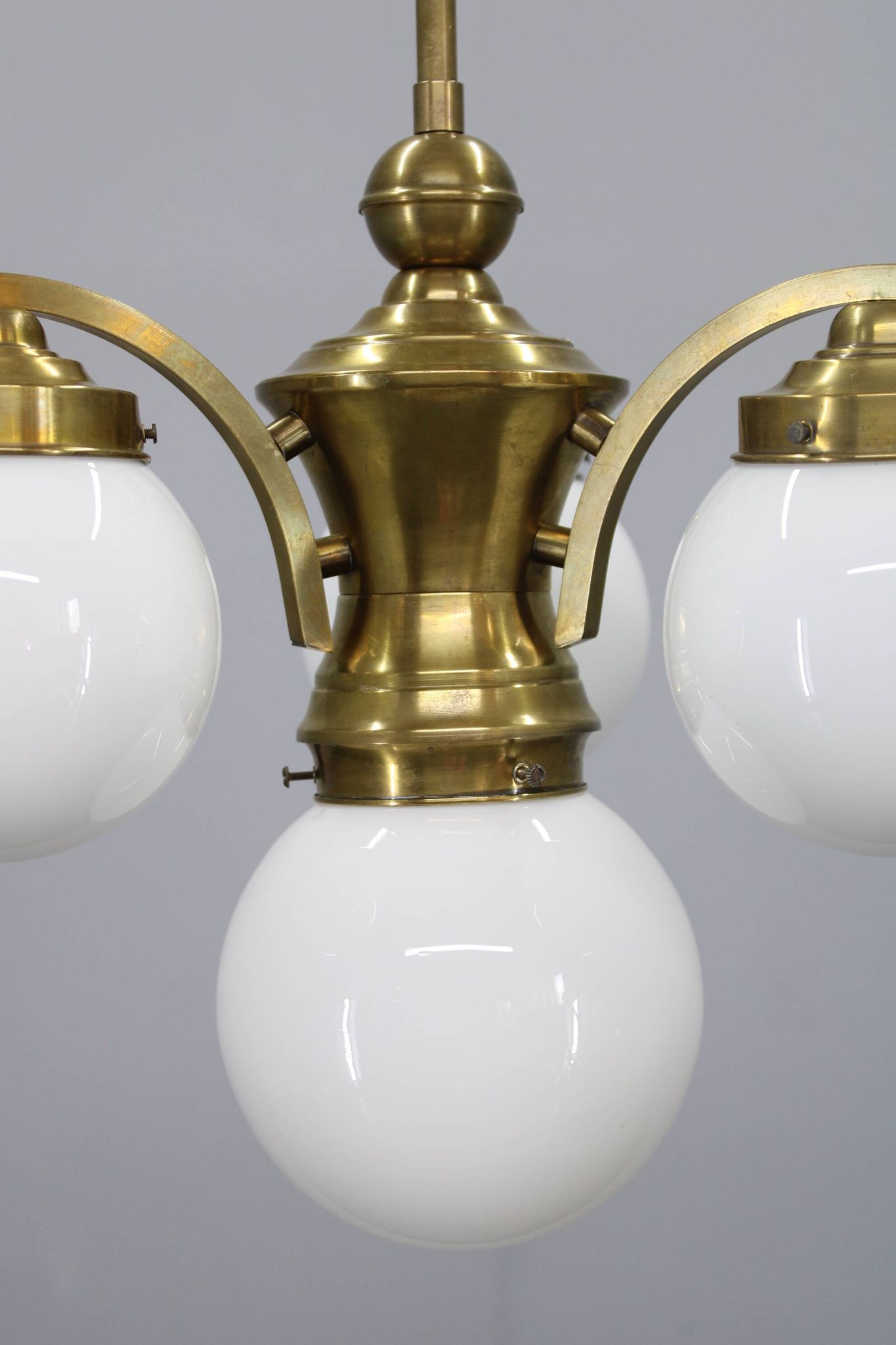 1930s Czechoslovak Art Deco brass chandelier with four opaline glass globes