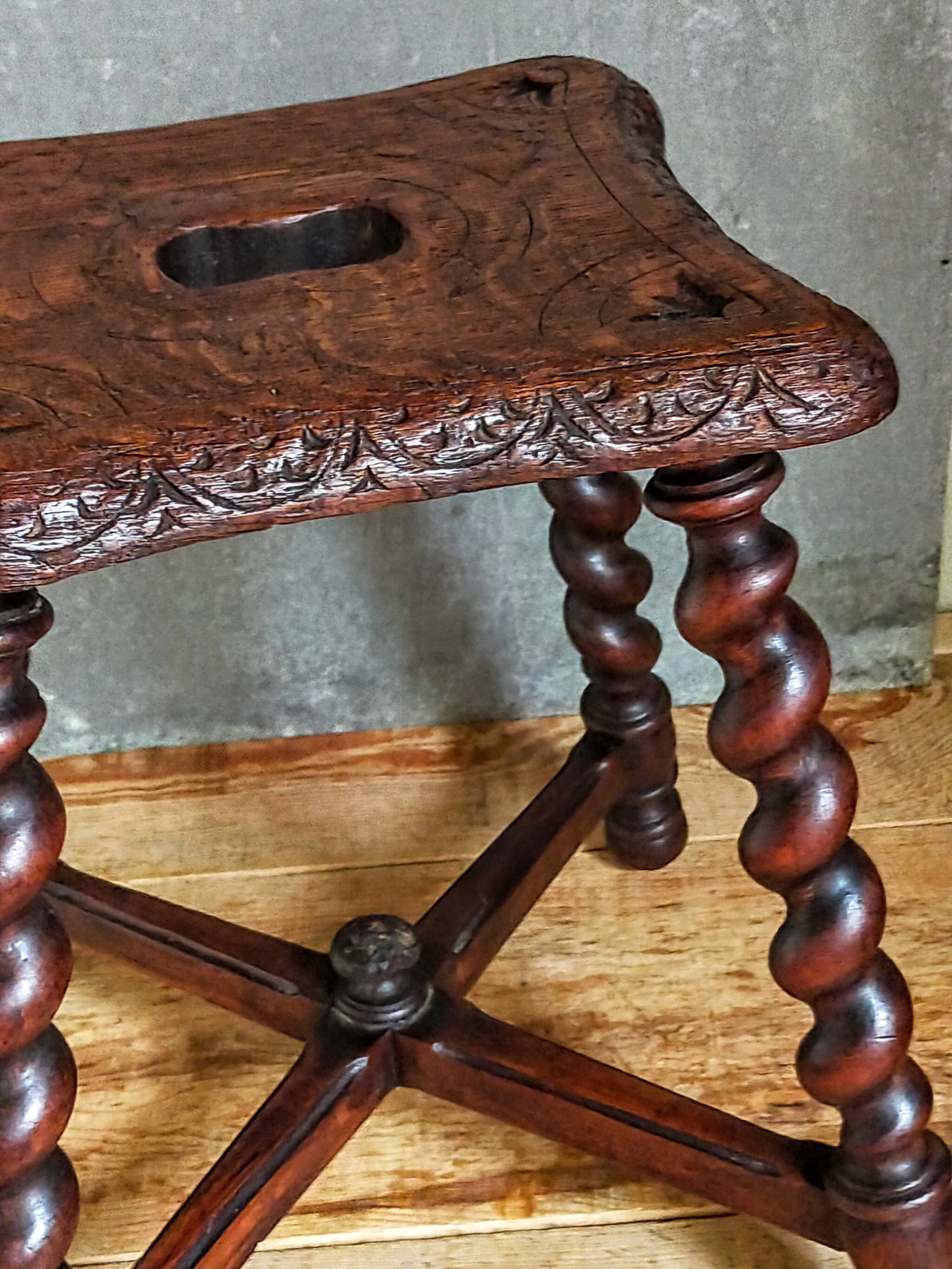 Antique stool in turned and carved solid wood