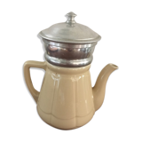 Old tea pot or coffee maker in faience cream with filter.
