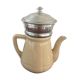Old tea pot or coffee maker in faience cream with filter.