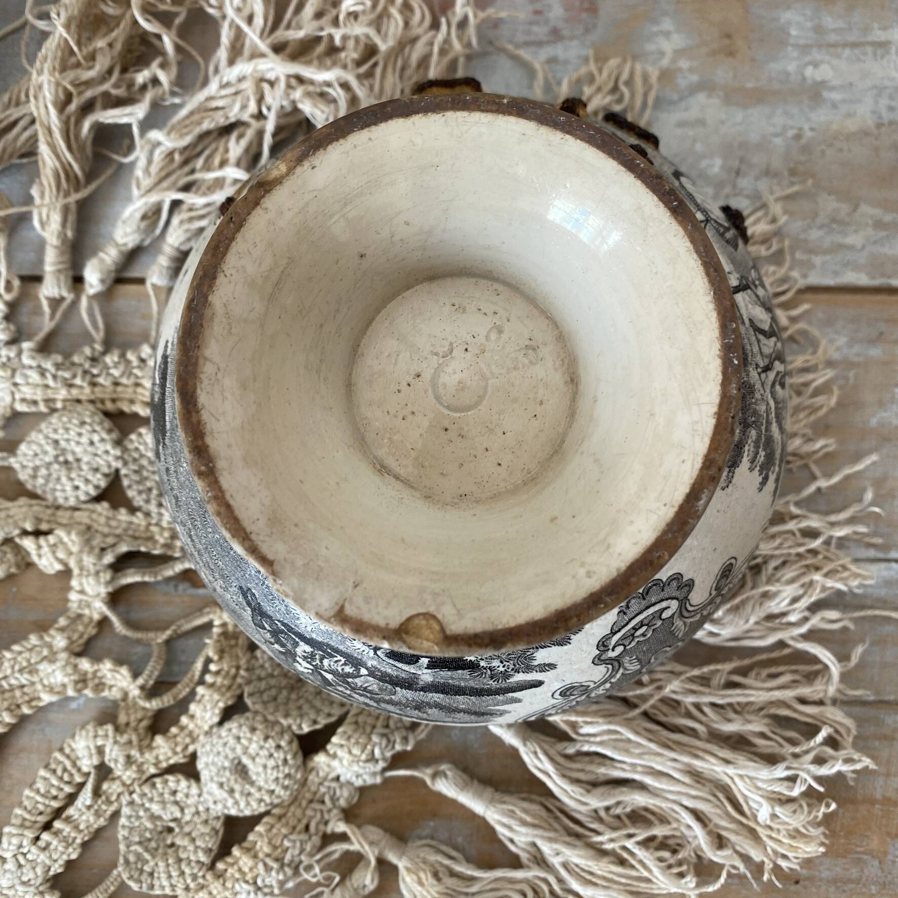 Old bowl made of iron with ceramic seams.