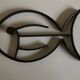 Modernist fish trivet in beaten iron, 1960.