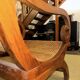 Colonial planter's armchair in solid teak, scroll armrests, caned seat.