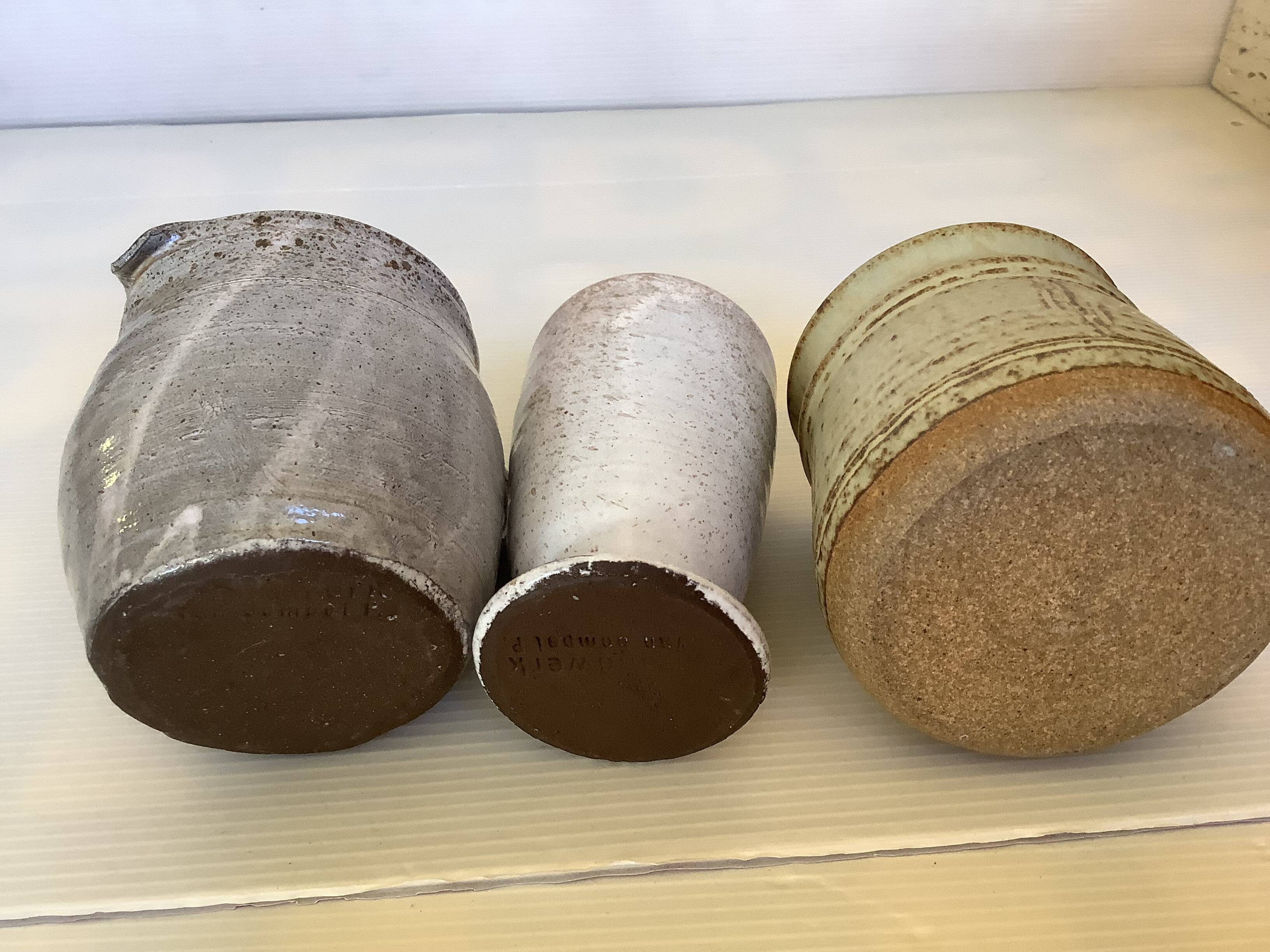 Seven beige and gray ceramic vases