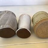 Seven beige and gray ceramic vases