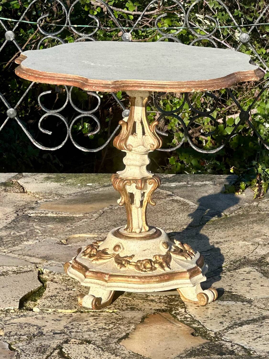 Carved and lacquered wooden side table.