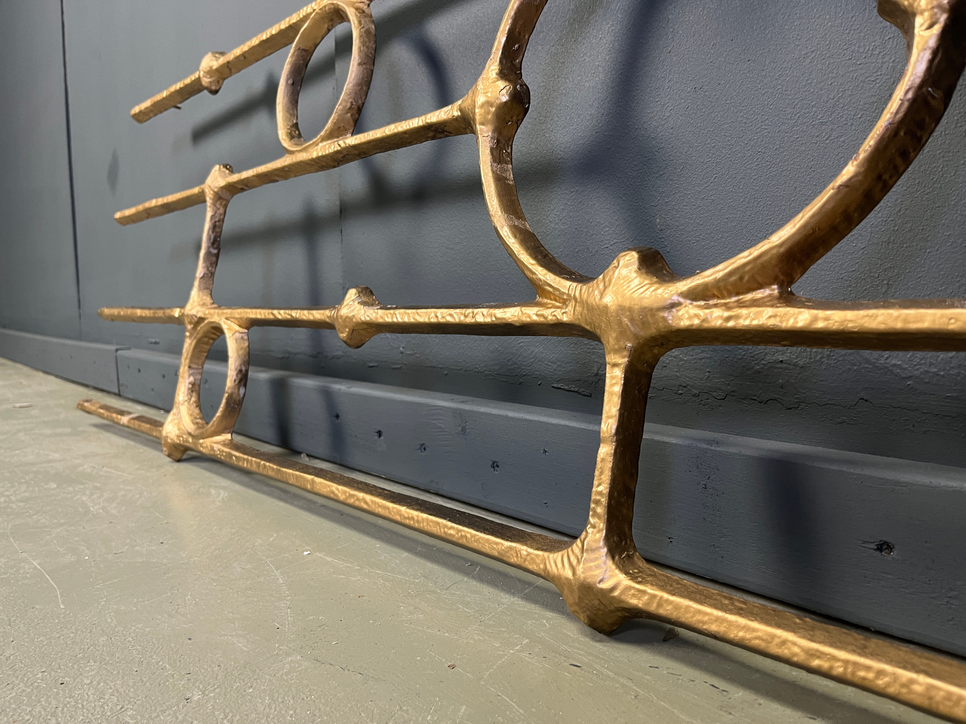 Architectural brutalist wall mounted sculpture made from cast metal.