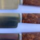 12 table knives stainless steel blade round ends / Bakelite handles with wood burl effect / 1950s