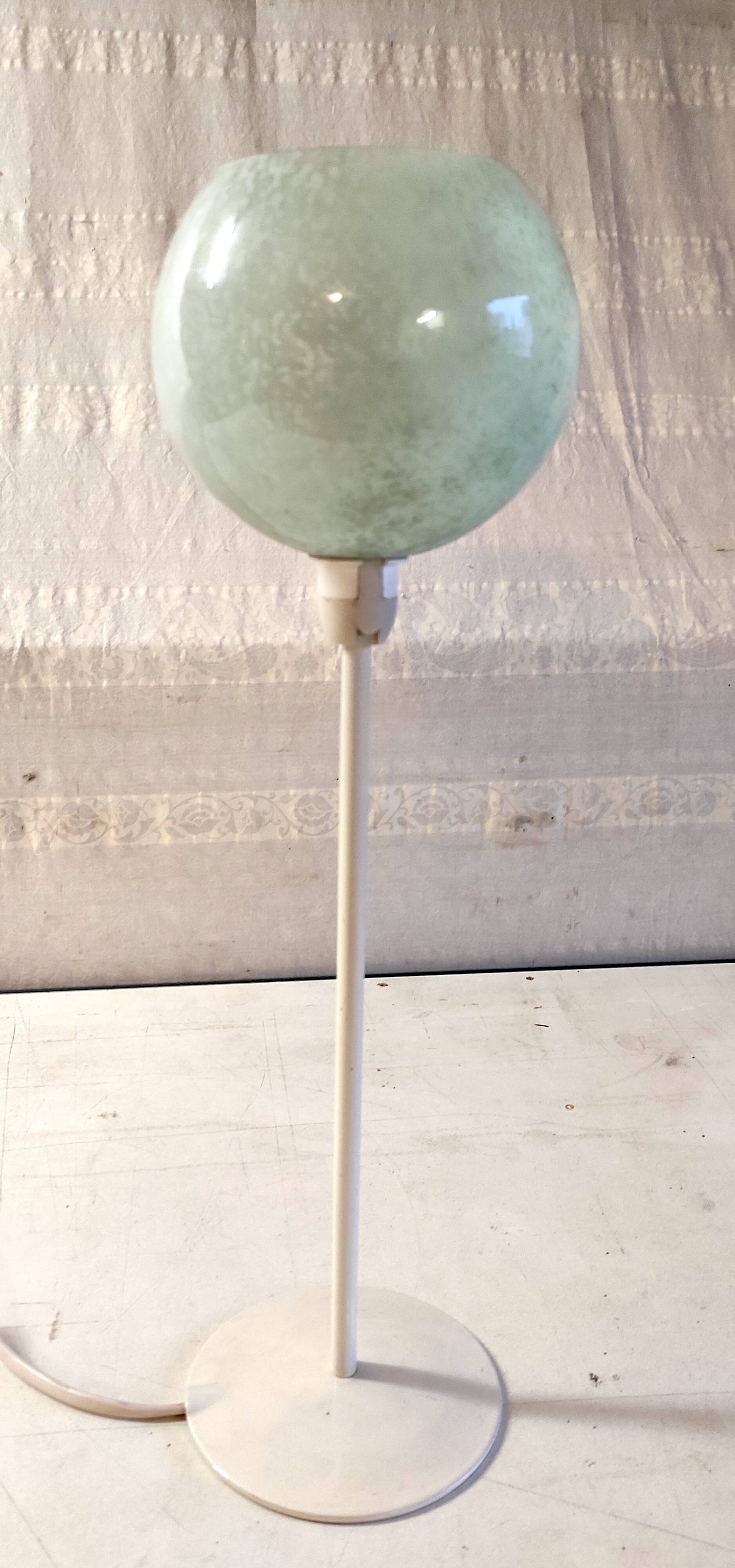 Table lamp with a pale green Clichy glass globe.