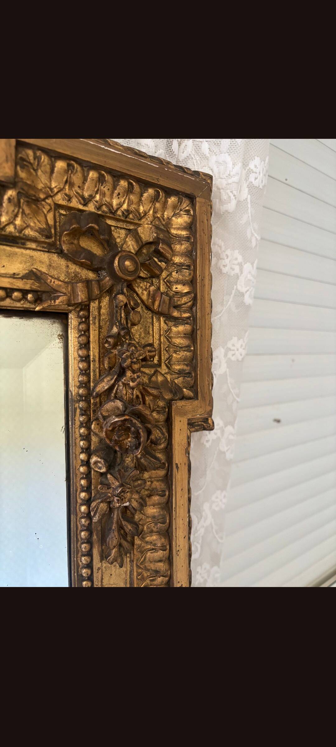 Large mirror from the Napoleonic III era with a floral pediment.
