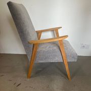 Vintage armchair reupholstered in light grey.
