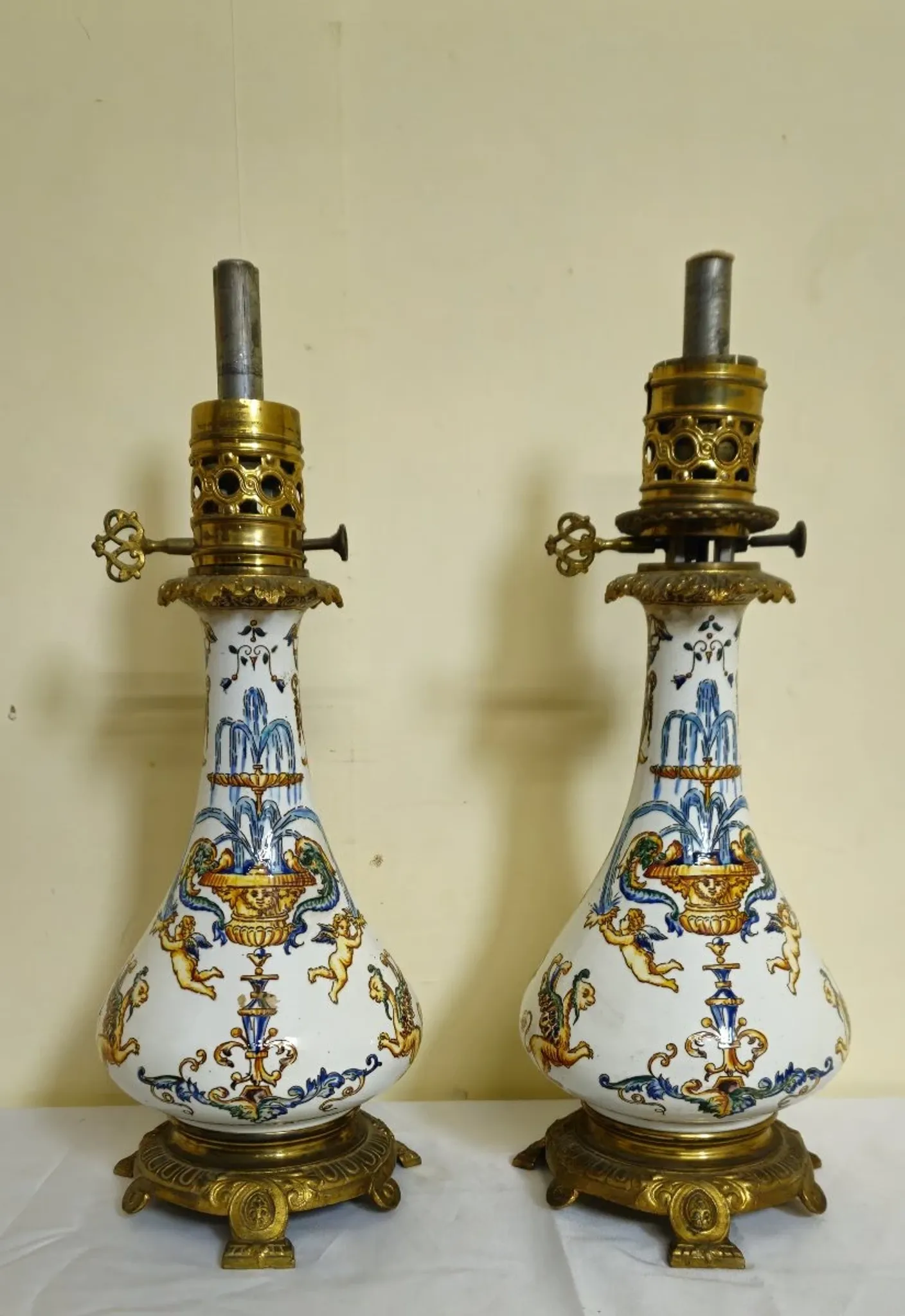 Gien: pair of antique oil lamps in fine earthenware richly decorated.