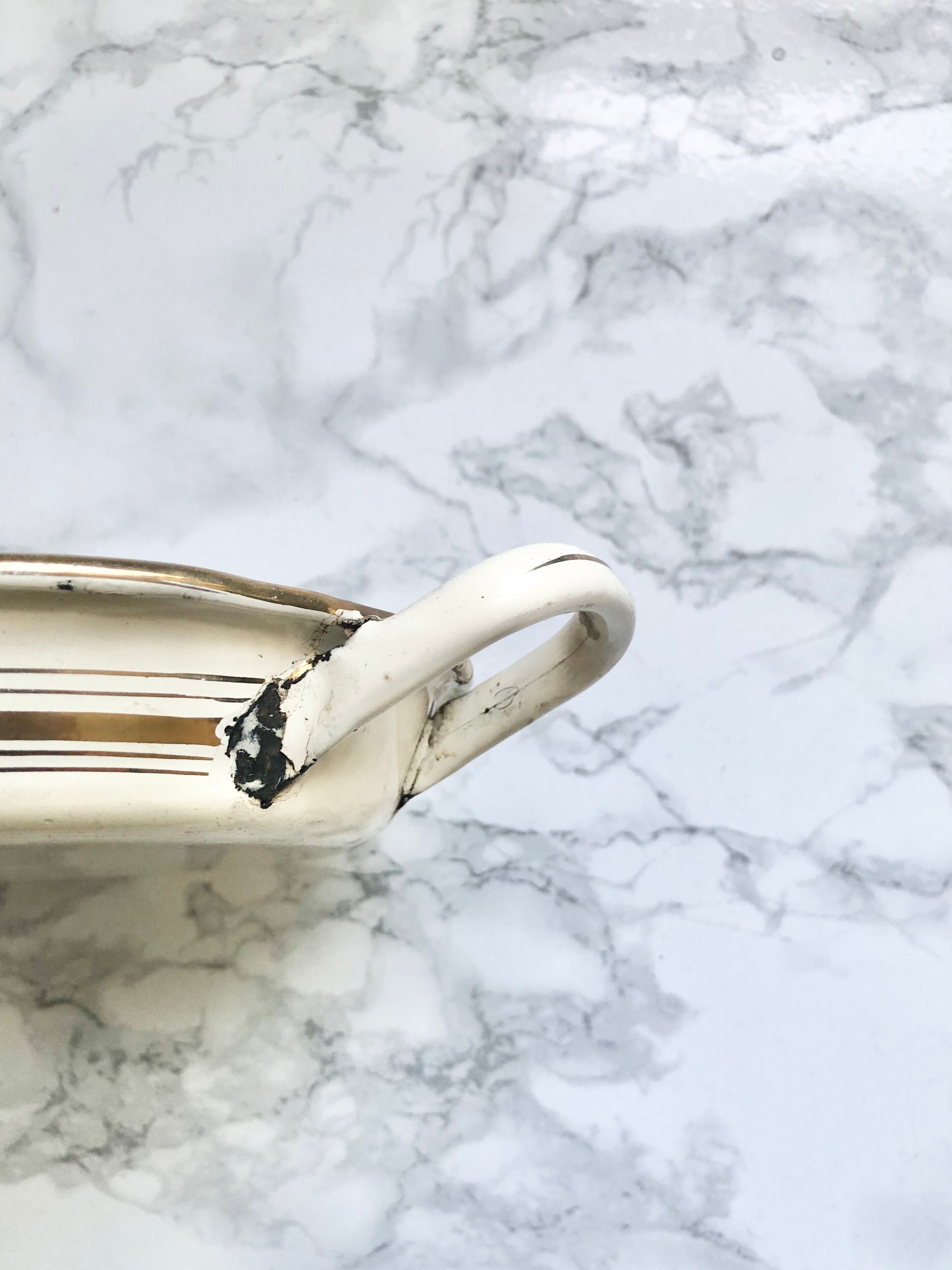 Old egg dish in creamy white and golden enamelled sheet