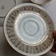 Solitaire tea cup, saucer, and dessert plate in white and gold.