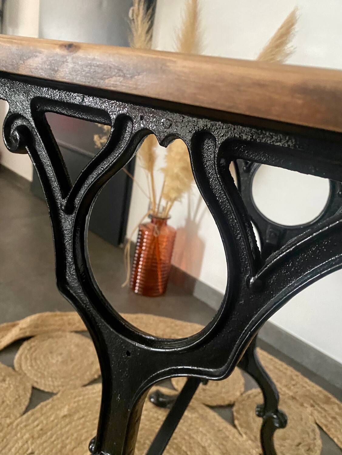 Bistro table with iron legs and raw wood top.