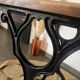 Bistro table with iron legs and raw wood top.