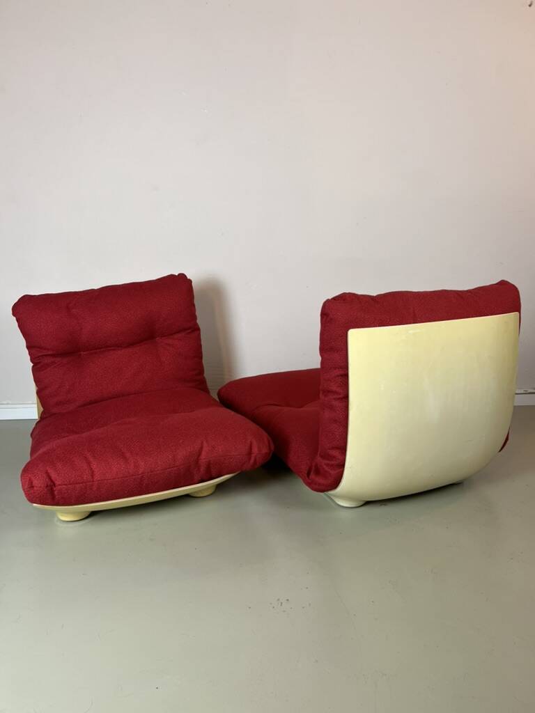 Vintage red shell lounge chairs from the 70s mid-century retro.