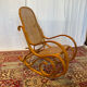 Antique rocking chair in curved wood and caning.