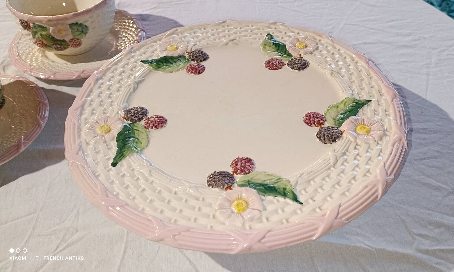 Footed dessert plate in barbotine porcelain, marked FG.