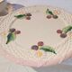 Footed dessert plate in barbotine porcelain, marked FG.