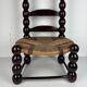 Brutalist wood turned bobbin low rush chair n the style of Charles Dudouyt
