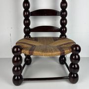 Brutalist wood turned bobbin low rush chair n the style of Charles Dudouyt