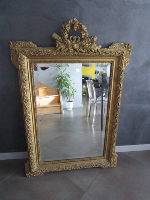 Large antique mirror in wood and gilded stucco.