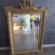 Large antique mirror in wood and gilded stucco.