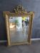 Large antique mirror in wood and gilded stucco.