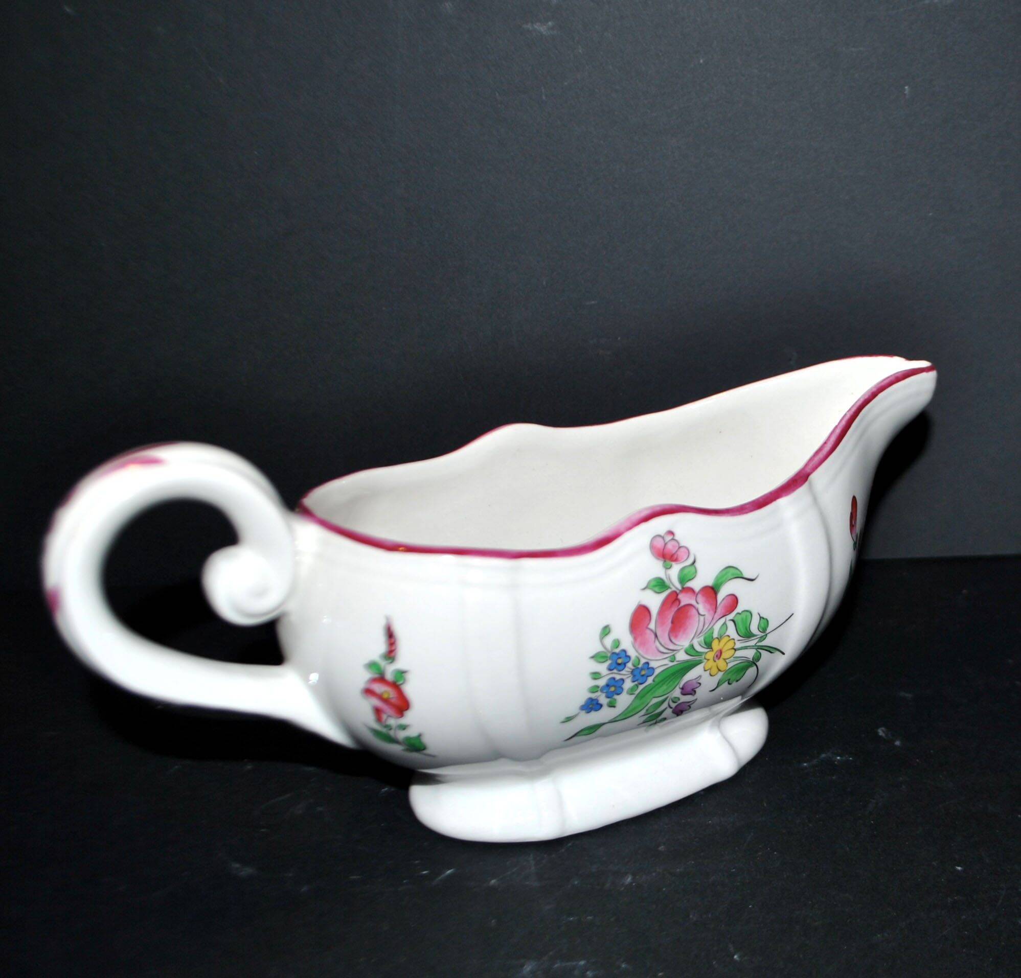 Lunéville KG earthenware sauce boat with polychrome painted flowers, revolving lamp.