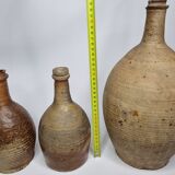 Set of three old enamelled terracotta bottles, 33 cm