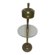 Vintage brass floor ashtray with glass shelf in Empire style.